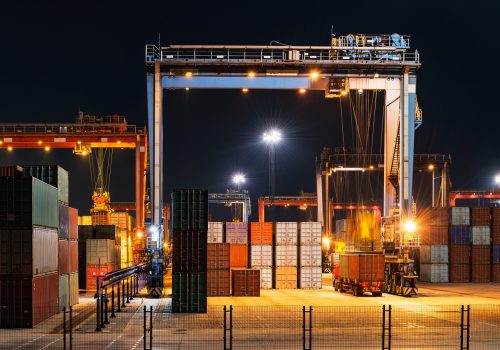 Industrial crane loading Containers in a Cargo freight ship