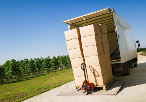 Truck transporting goods packed in boxes from warehouse