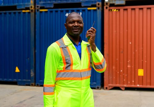 Warehouse engineer worker working at container yard. Logistics and Transportation. High quality photo